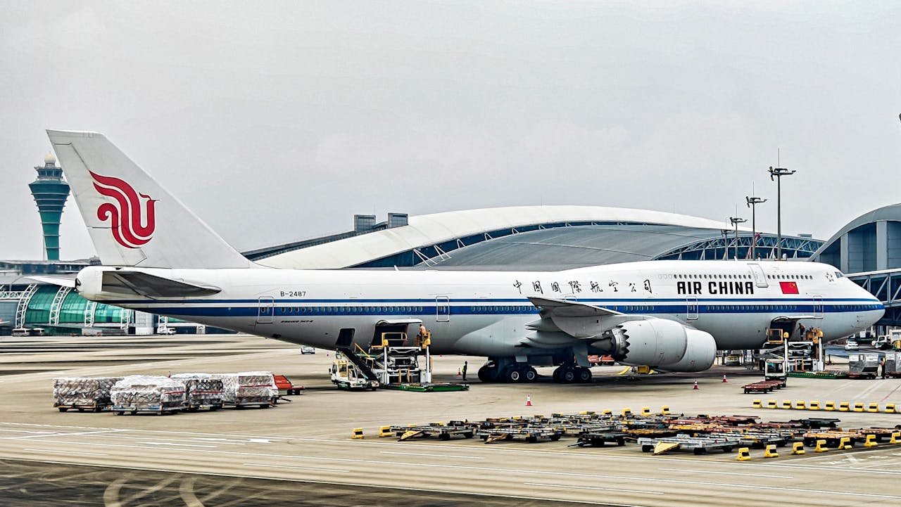 Home Air China Boeing 747-8 at airport terminal with cargo loading.