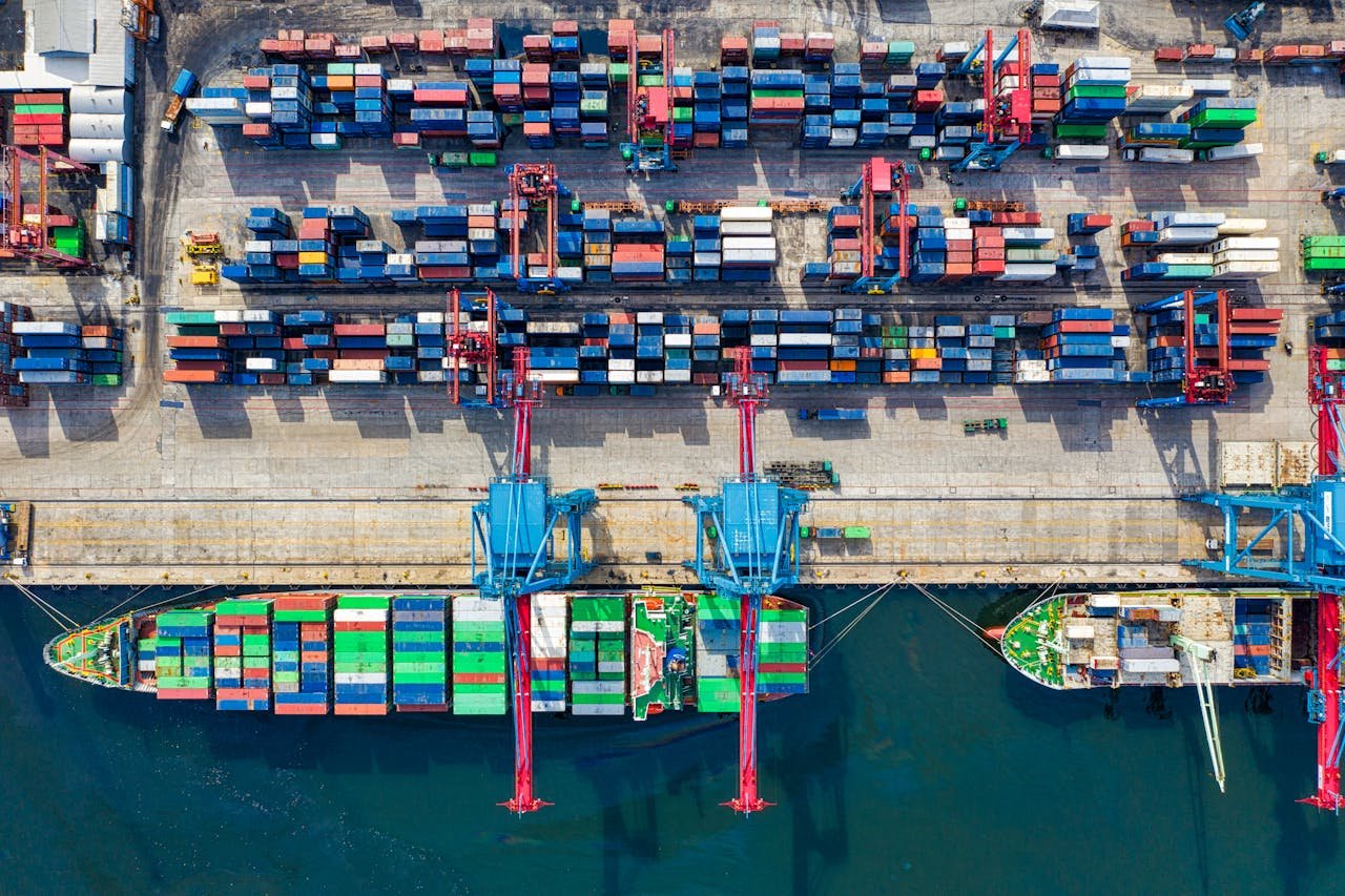 Home Drone shot capturing vibrant container ships and dock in North Jakarta port, Indonesia.