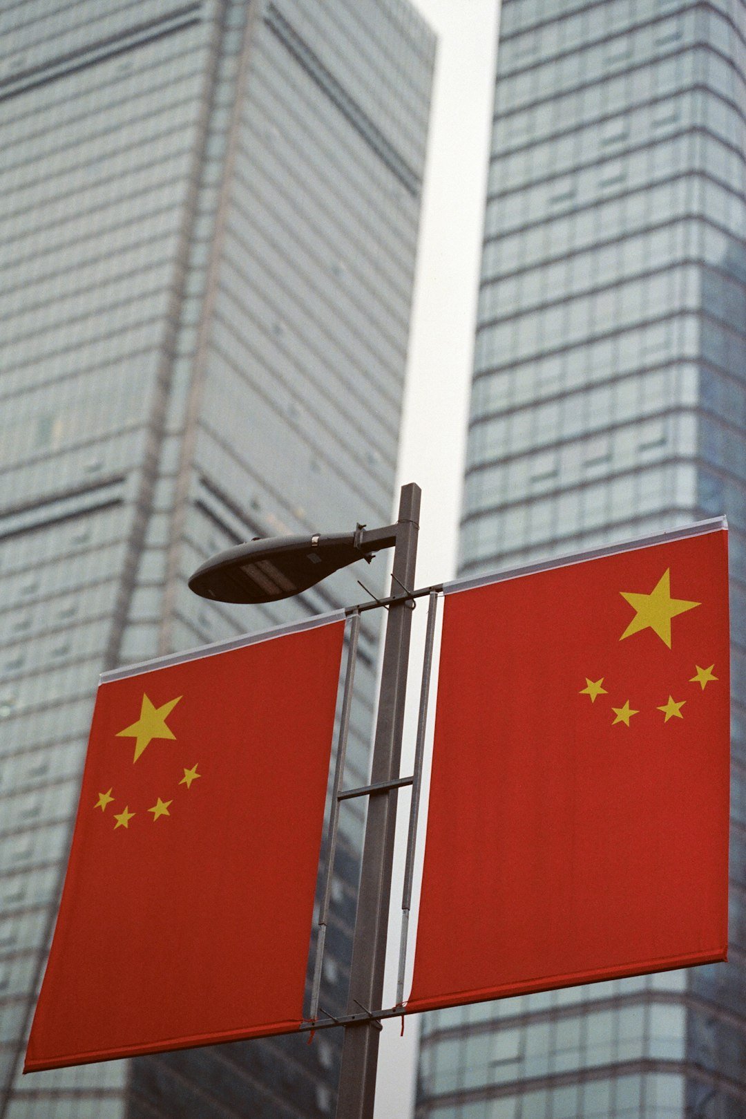 Services two-chinese-flags-on-a-pole-with-skyscrapers-behind-ujzlhepywgm